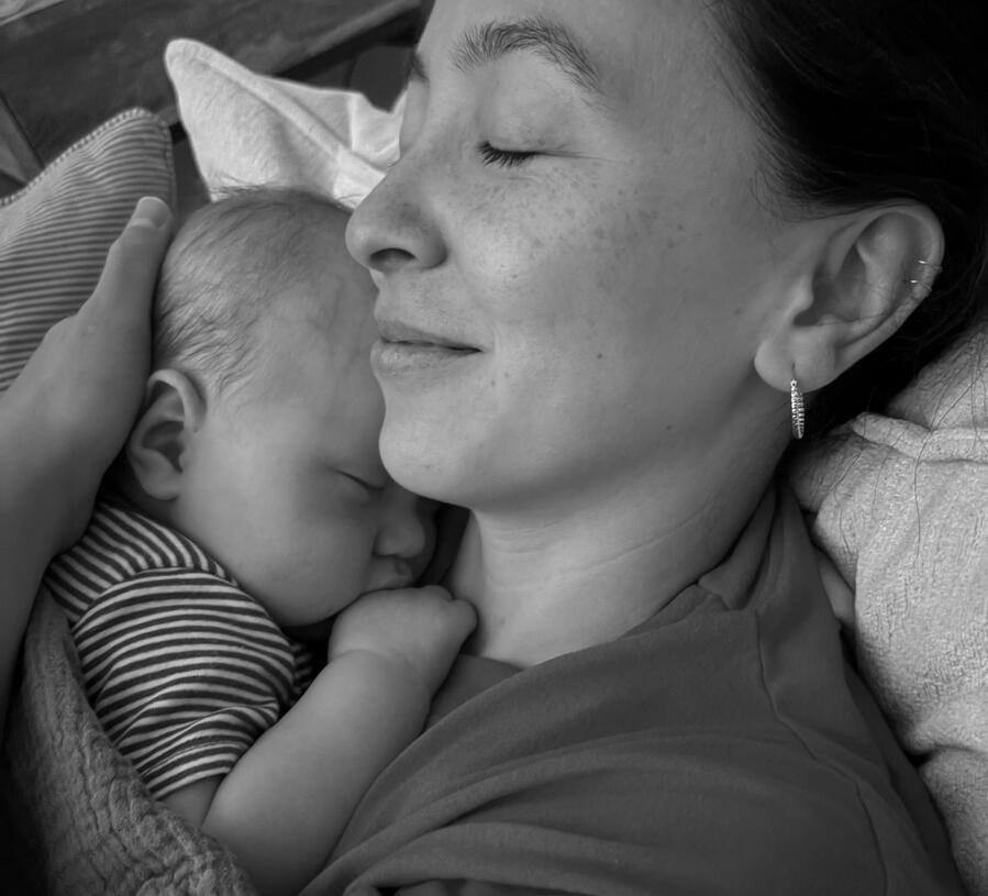 Liz & Casper person cuddles newborn